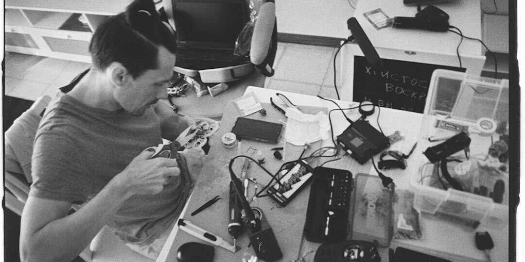Technician working on laptop electronics for screen and keyboard repair