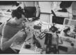 Technician working on laptop electronics for screen and keyboard repair
