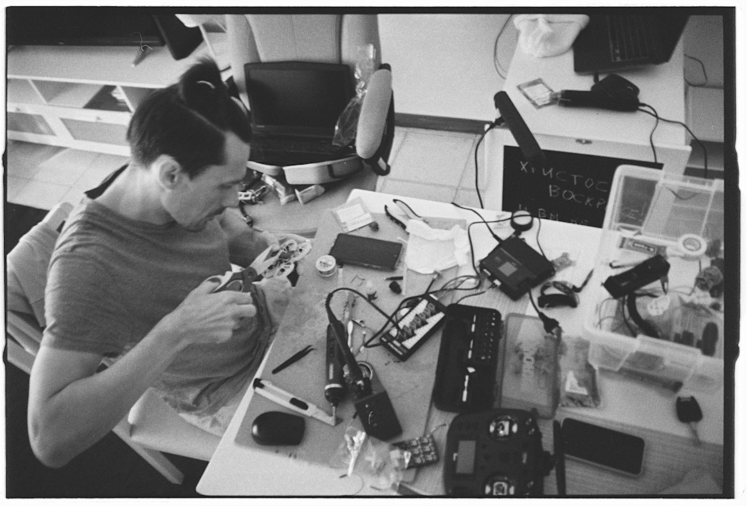 Technician working on laptop electronics for screen and keyboard repair