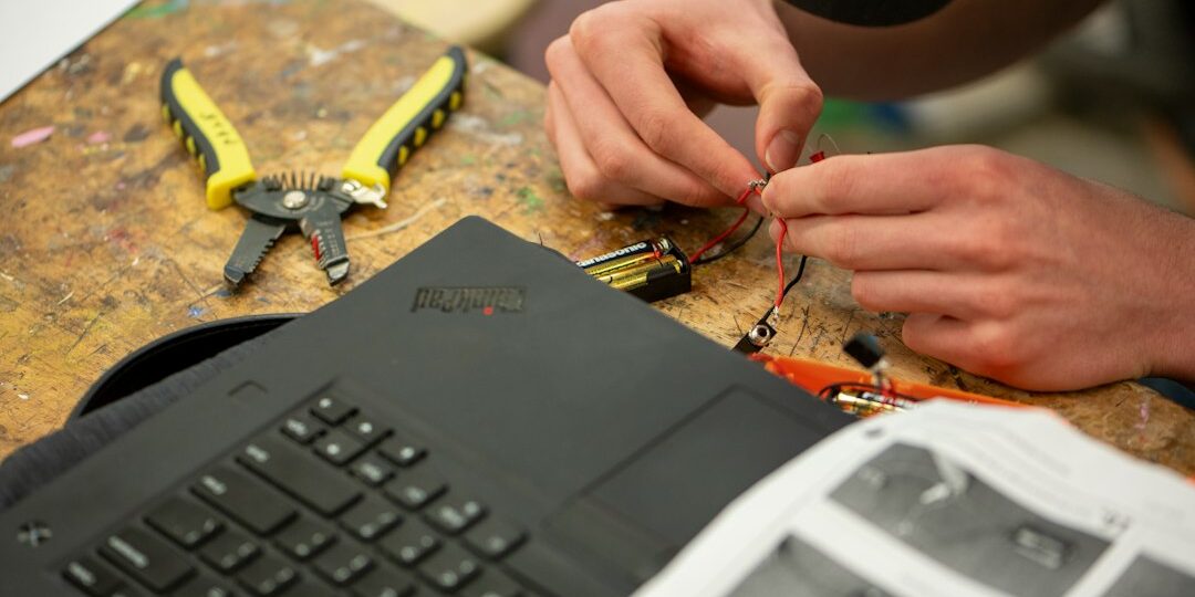 Technician repairing a laptop at a service center workbench in Hyderabad