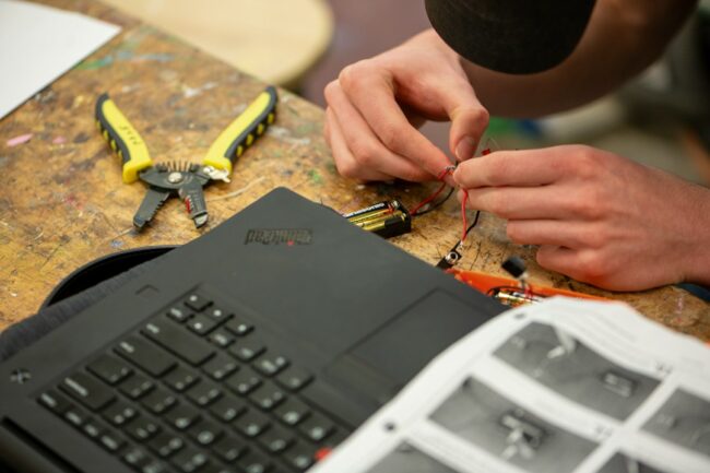 Technician repairing a laptop at a service center workbench in Hyderabad